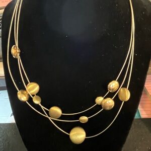 Wired necklace with bronze colored beads on the necklace. No signature or marks.